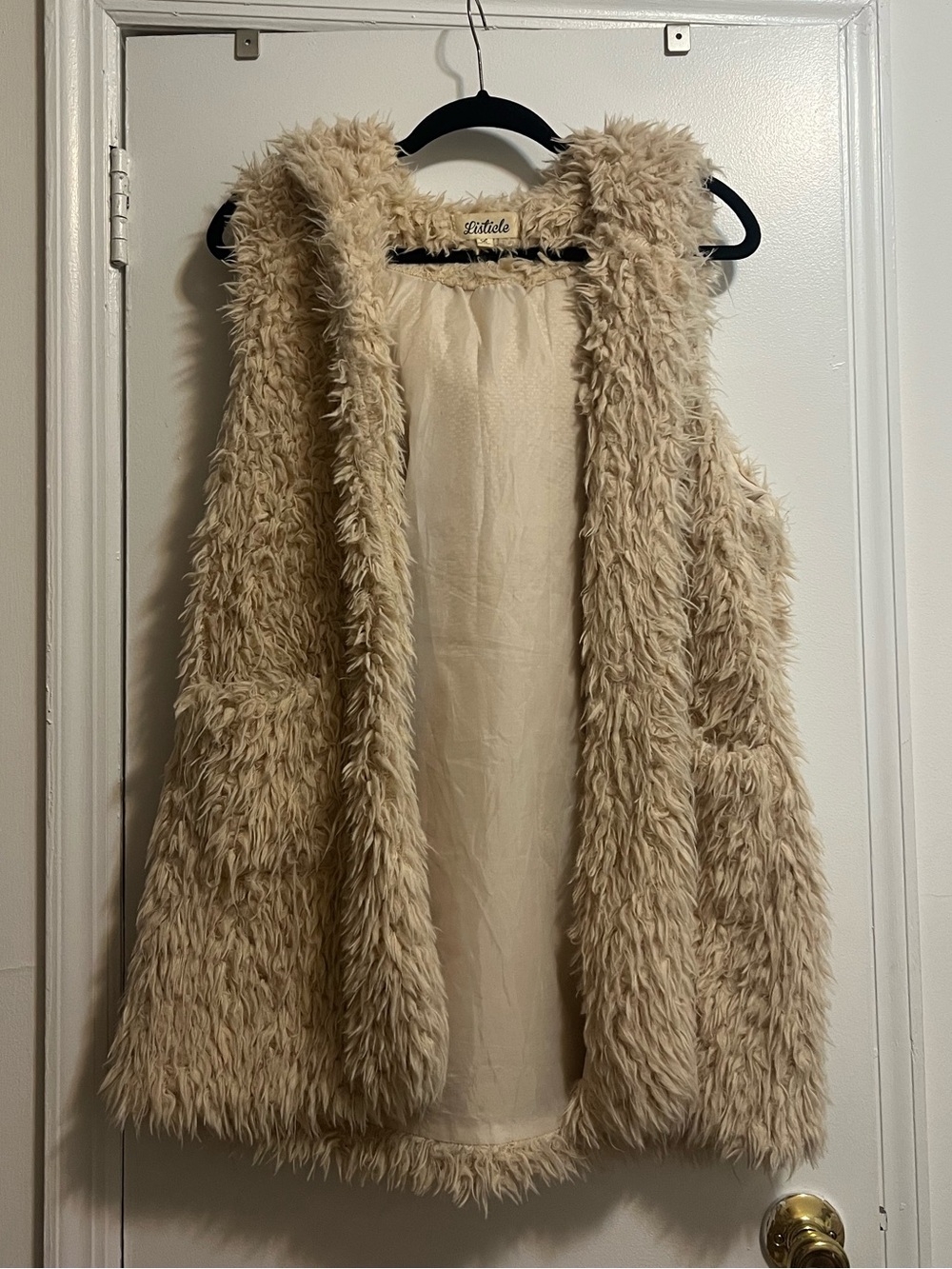 Tan furry hooded vest with front pockets